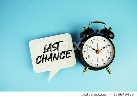 Last Chance text on speech bubble with alarm clock on blue background 136649450