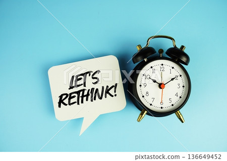 Let's Rethink! text on speech bubble with alarm clock on blue background 136649452