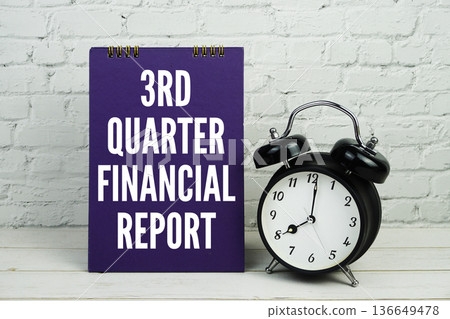 3rd Quarter Financial Report text with alarm clock on white brick wall and wooden background 136649478