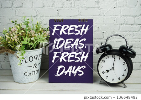Fresh Ideas, Fresh Days text with alarm clock on wooden background Fresh Ideas, Fresh Days text with alarm clock on wooden background 136649482