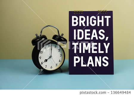 Bright Ideas, Timely Plans text with alarm clock on yellow and blue background Bright Ideas, Timely Plans text with alarm clock on yellow and blue background 136649484
