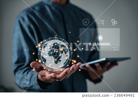 Education and online learning technology are shown as someone holds tablet with icons symbolizing e-learning and global connectivity, so users learn about virtual classrooms and also learn new skills 136649491