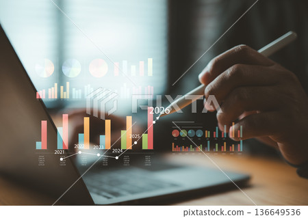 Business analytics and data visualization with projected growth and chart analysis using digital pen and laptop Business analytics and data visualization with projected growth and chart analysis using digital pen and laptop 136649536