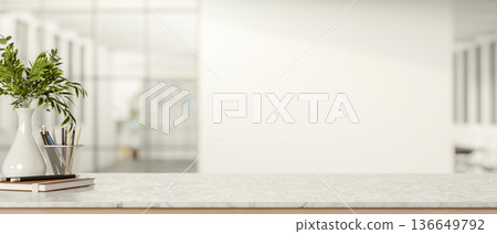Pencil storage and book aside a plant vase on marble counter table in white wall room with sunlight Pencil storage and book aside a plant vase on marble counter table in white wall room with sunlight 136649792