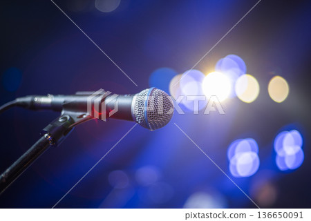 the artist's microphone stands on stage at a concert the artist's microphone stands on stage at a concert 136650091