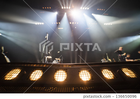 the light shines on the stage at a concert in the hall the light shines on the stage at a concert in the hall 136650096