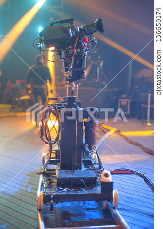 TV dolly camera on the set of a concert live broadcast TV dolly camera on the set of a concert live broadcast 136650174