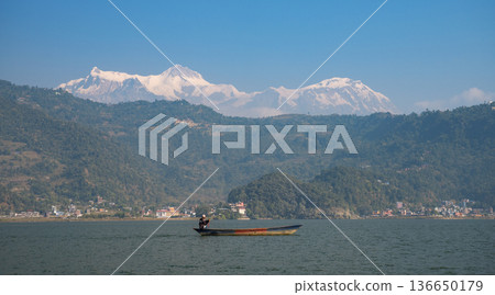 Fisherman in Phewa Lake with Annapurna Mountain in the background. Pokhara. Fisherman in Phewa Lake with Annapurna Mountain in the background. Pokhara. 136650179