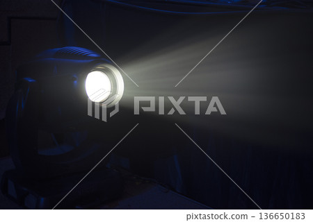 professional lighting fixture shines with a beam of light 136650183
