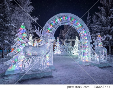 Christmas Ice Sculptures with Illuminated Reindeer and Archway at Night 136651354