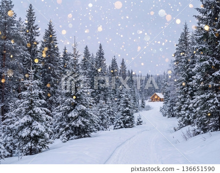 Christmas winter wonderland with snowy forest and cozy cabin 136651590