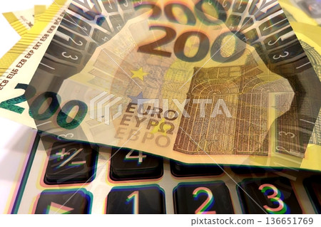 Calculator and Euro Bills. A professional stock photo of 200 euro banknotes on a calculator. Calculator and Euro Bills. A professional stock photo of 200 euro banknotes on a calculator. 136651769