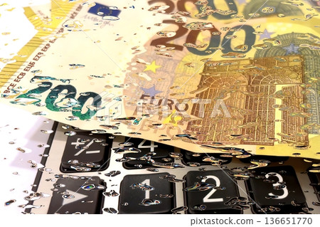 Calculator and Euro Bills. A professional stock photo of 200 euro banknotes on a calculator. Calculator and Euro Bills. A professional stock photo of 200 euro banknotes on a calculator. 136651770