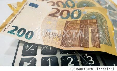 Calculator and Euro Bills. A professional stock photo of 200 euro banknotes on a calculator. Calculator and Euro Bills. A professional stock photo of 200 euro banknotes on a calculator. 136651771