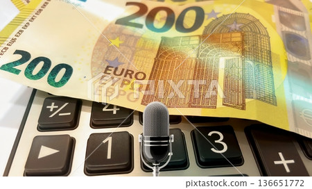 Calculator and Euro Bills. A professional stock photo of 200 euro banknotes on a calculator. 136651772