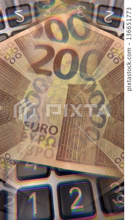Calculator and Euro Bills. A professional stock photo of 200 euro banknotes on a calculator. 136651773