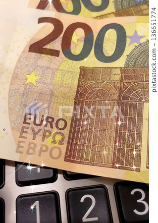 Calculator and Euro Bills. A professional stock photo of 200 euro banknotes on a calculator. Calculator and Euro Bills. A professional stock photo of 200 euro banknotes on a calculator. 136651774