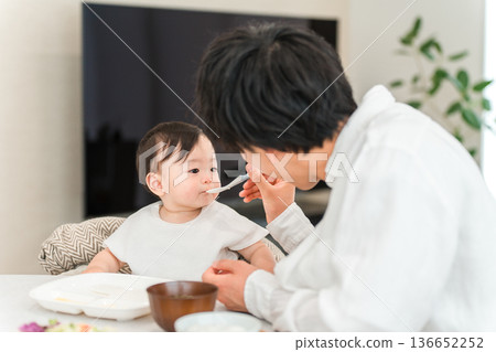 Father feeding baby food and rice (childcare and parenting) Father feeding baby food and rice (childcare and parenting) 136652252