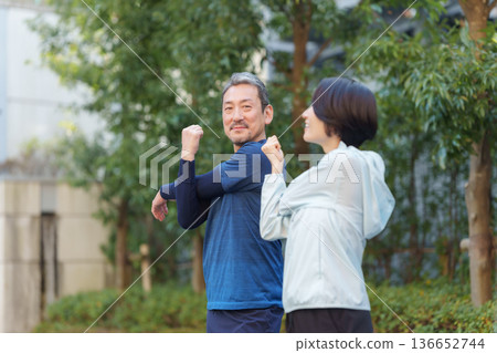 Men and women exercising 136652744