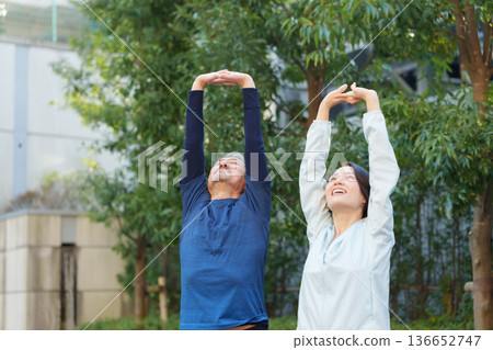 Men and women exercising 136652747