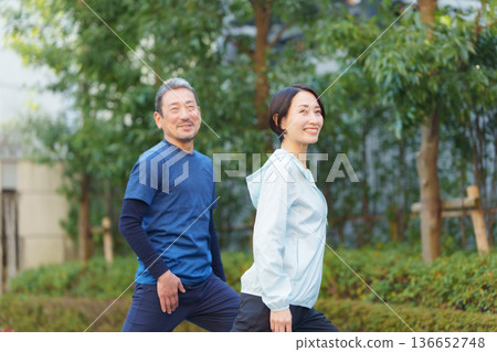 Men and women exercising 136652748