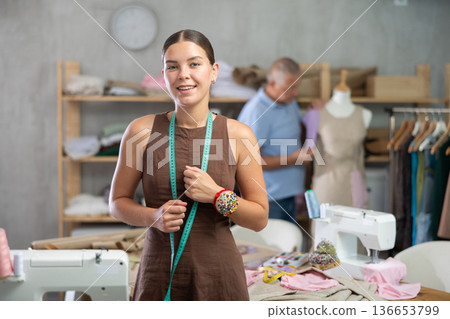 Girl fashion designer is in office, senior man tailor apprentice work with mannequin 136653799