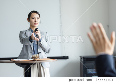 Young woman speaking with a microphone Young woman speaking with a microphone 136654704
