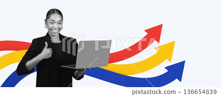 A person is standing and smiling while holding a laptop. They show a thumbs up, indicating achievement. A person is standing and smiling while holding a laptop. They show a thumbs up, indicating achievement. 136654839