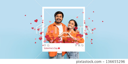 A couple stands together, smiling and forming a heart shape with their hands. They are surrounded by heart-shaped graphics. The background is blue, and a frame looks like a social media post. 136655296