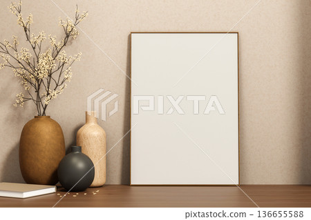 White drawing or photo frame leaning against wall with flower vases and book on wooden counter table White drawing or photo frame leaning against wall with flower vases and book on wooden counter table 136655588