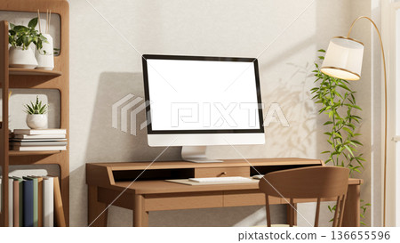 White screen computer on wooden table and chair aside bookshelf with lamp and houseplant in sunlight 136655596
