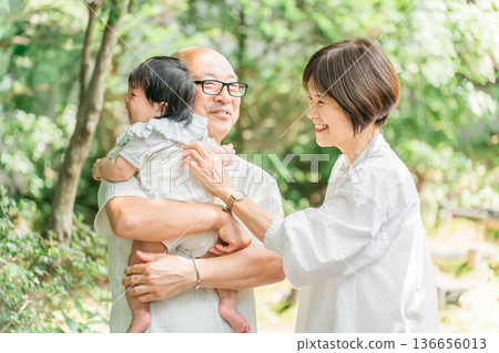 一對老年夫婦抱著他們的孫子（回家，第一個孫子，回家，父母回家） 136656013