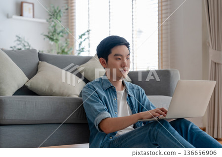 Young Asian man relaxing on comfortable couch 136656906