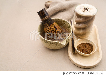 Preparing cacao latte with bamboo whisk and powder Preparing cacao latte with bamboo whisk and powder 136657132