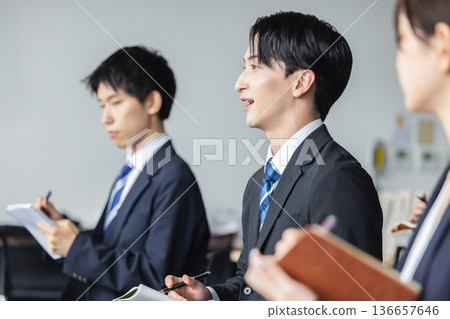 Business people participating in a seminar 136657646