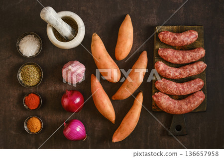 Natural casing sausages with sweet potatoes and spices on a wooden table during daytime Natural casing sausages with sweet potatoes and spices on a wooden table during daytime 136657958