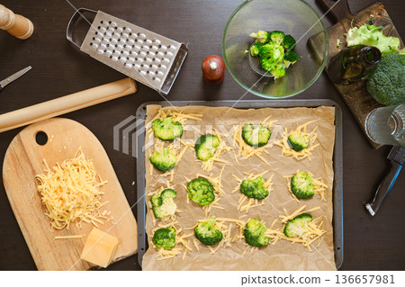 Ingredients for smashed broccoli with cheese are on dark kitchen table 136657981