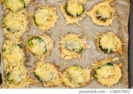 Smashed broccoli with cheese prepared on a baking sheet in a kitchen 136657982