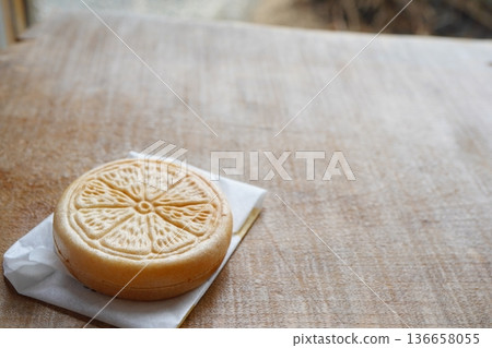 Lemon-patterned Japanese sweets on a wooden table 136658055