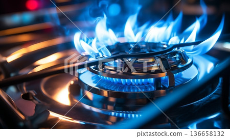 Closeup shot of blue fire from domestic kitchen stove top. Gas cooker with burning flames of propane gas. Industrial resources and economy concept. 136658132