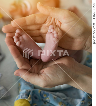 Mother touching small baby feet. Mother touching small baby feet. 136660158