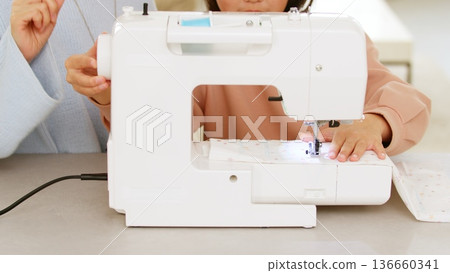 Sewing machine hand image Sewing machine hand image 136660341