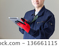 Middle-aged male businessman in work clothes holding a tablet 136661115