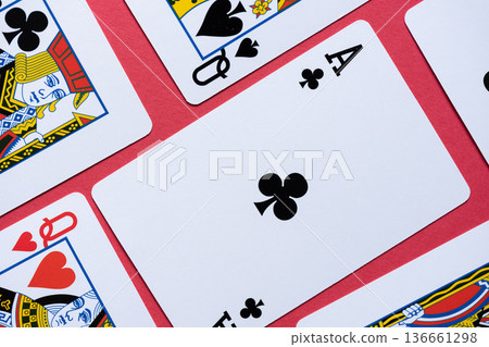 Playing cards lined up on a red background Playing cards lined up on a red background 136661298