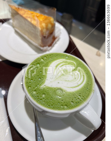 Green matcha latte with heart latte art and cake Green matcha latte with heart latte art and cake 136663699