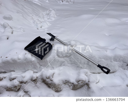 Broken snow shovel failing in heavy snow 136663704