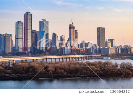 Seoul, Korea - Feb. 16, 2026 : A building in Yeouido, Seoul's financial district in Korea, taken just before sunset, and the cityscape of the Han River 136664212