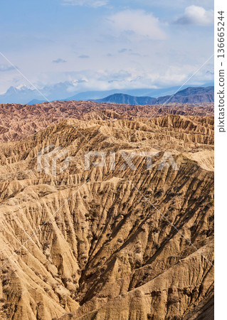 Dry Aksai canyon landscape in Kyrgyzstan with desert mountains. Scenic nature view for travel background and adventure tourism poster. Dry Aksai canyon landscape in Kyrgyzstan with desert mountains. Scenic nature view for travel background and adventure tourism poster. 136665244