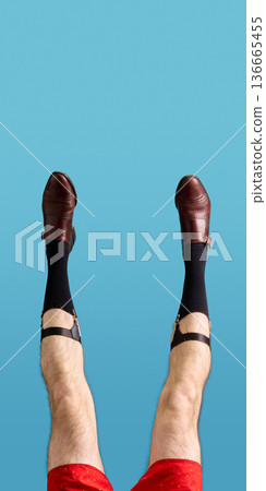 Brown leather men shoes with garter straps and black socks on blue background 136665455