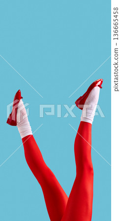 Female legs in red tights and red pumps on blue background. 136665458